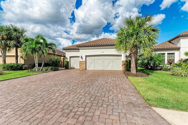 mediterranean / spanish home with a front lawn