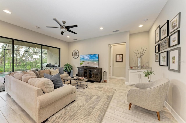 living room with light wood-type flooring and ceiling fan