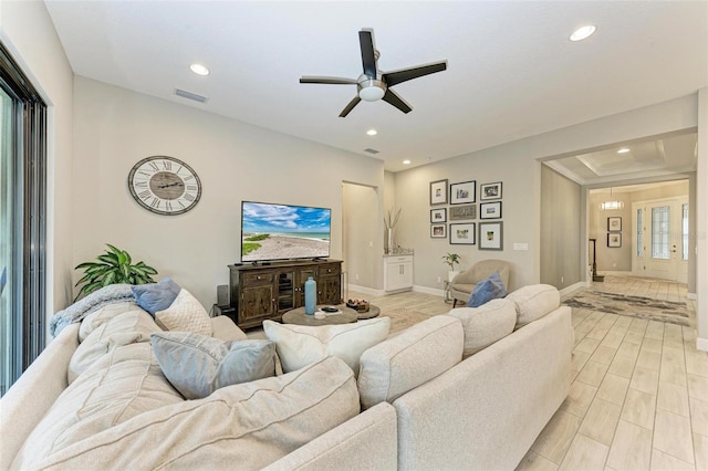 living room featuring light hardwood / wood-style floors and ceiling fan