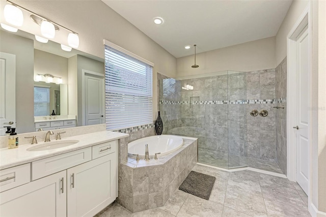 bathroom with tile patterned flooring, vanity, and separate shower and tub