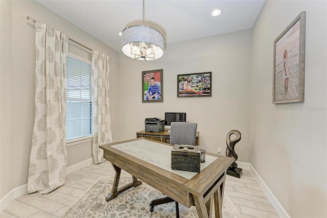 office with an inviting chandelier and light wood-type flooring