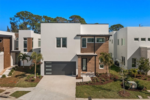 contemporary home featuring central AC unit and a garage