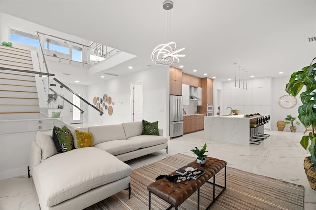 living room featuring sink and an inviting chandelier