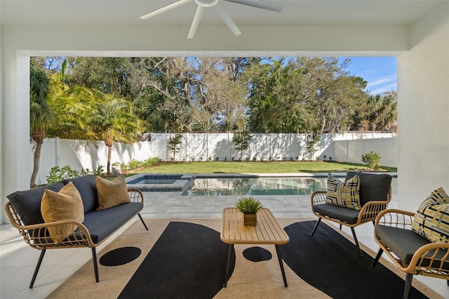 view of patio featuring ceiling fan and a fenced in pool