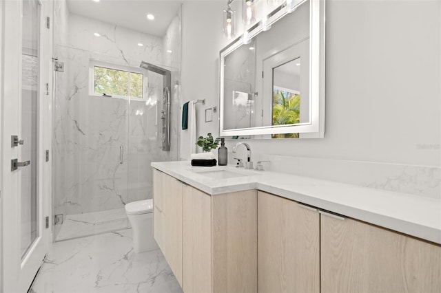 bathroom with vanity, a shower with door, plenty of natural light, and toilet