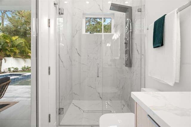 bathroom featuring vanity, toilet, and a shower with door