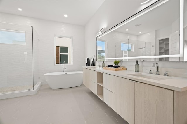 bathroom with vanity, a healthy amount of sunlight, tile patterned floors, and separate shower and tub