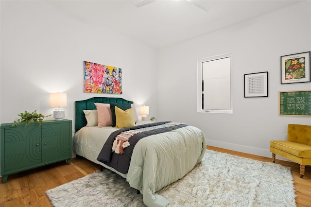 bedroom featuring hardwood / wood-style flooring and ceiling fan