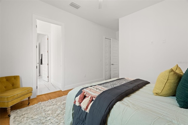 bedroom featuring a closet, hardwood / wood-style floors, and ceiling fan