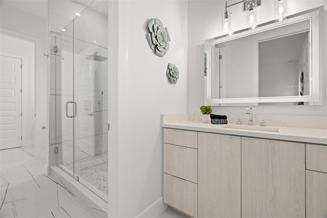 bathroom featuring a shower with shower door and vanity