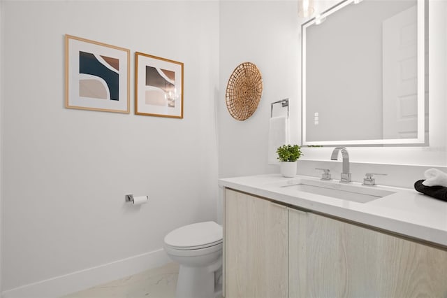 bathroom featuring toilet and vanity