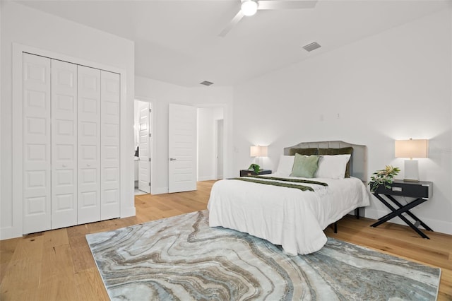 bedroom featuring hardwood / wood-style floors, ceiling fan, and a closet