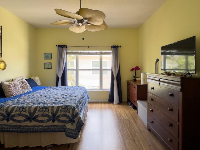 bedroom with light wood-type flooring and ceiling fan