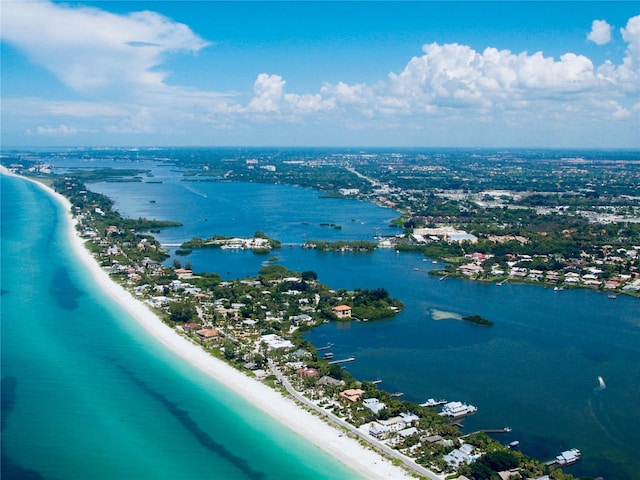 drone / aerial view with a water view and a view of the beach