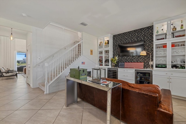 living room with bar, light tile patterned floors, and wine cooler