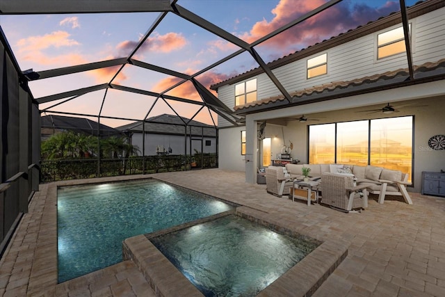 pool at dusk featuring outdoor lounge area, a patio, and glass enclosure