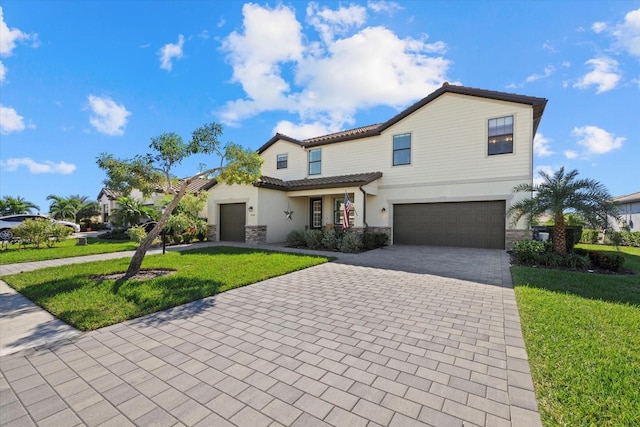 view of front of house featuring a front lawn and a garage