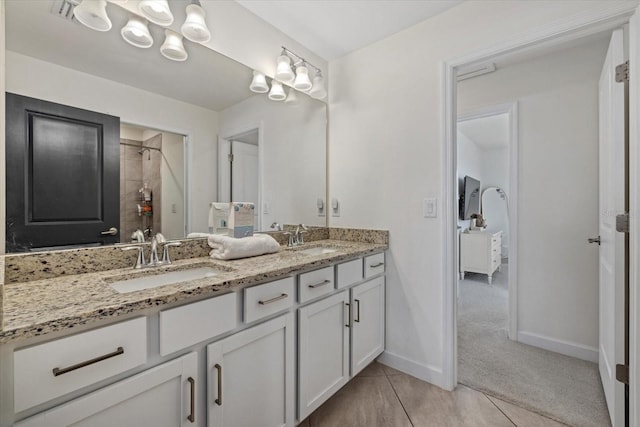 bathroom with tile patterned floors and vanity