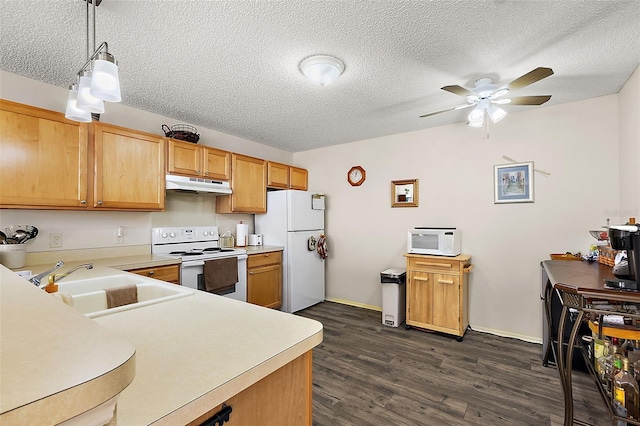 kitchen featuring sink, dark wood-type flooring, pendant lighting, a textured ceiling, and white appliances