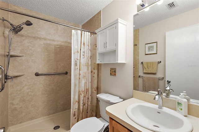 bathroom with toilet, vanity, a textured ceiling, and a shower with shower curtain