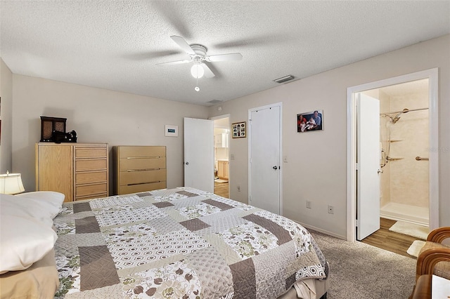 bedroom with ensuite bathroom, ceiling fan, a textured ceiling, and hardwood / wood-style flooring