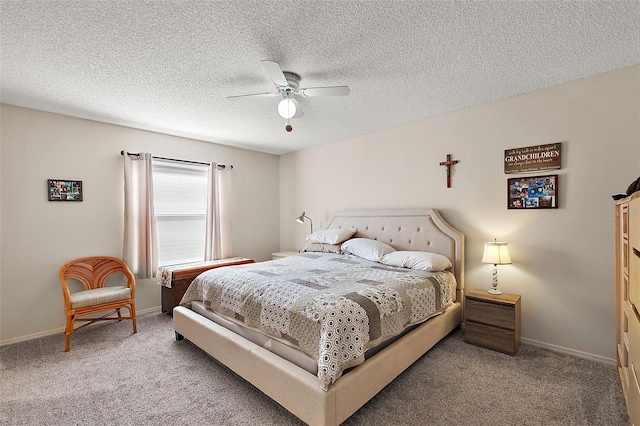 bedroom featuring carpet flooring, a textured ceiling, and ceiling fan