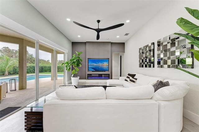 living room with ceiling fan and light hardwood / wood-style floors