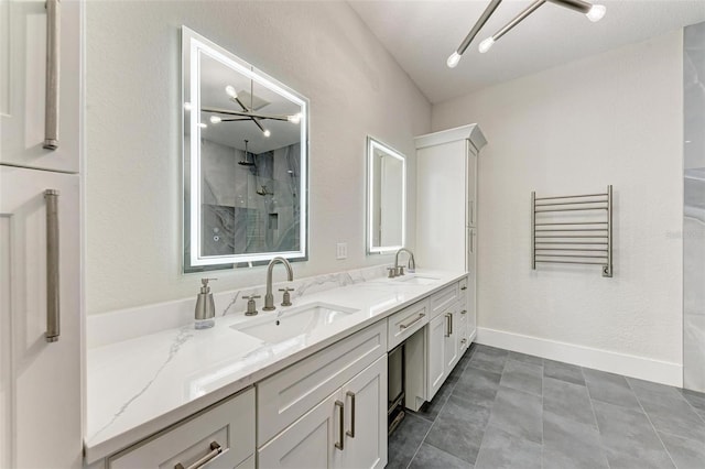 bathroom with walk in shower, vanity, tile patterned floors, and a notable chandelier