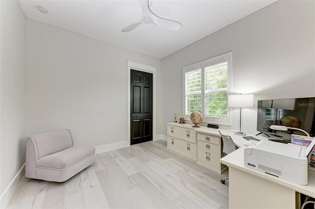 home office featuring light wood-type flooring and ceiling fan