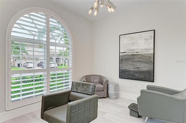 sitting room featuring light hardwood / wood-style floors and a chandelier