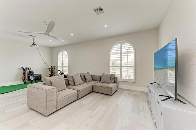 living room featuring light hardwood / wood-style floors and ceiling fan