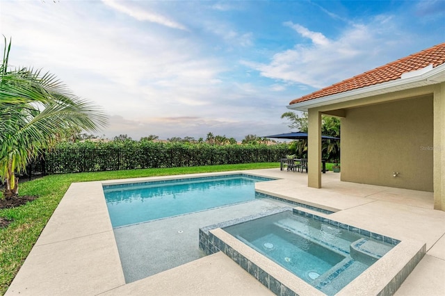 view of swimming pool with a patio area and an in ground hot tub