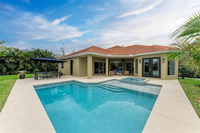 view of pool with a patio and an in ground hot tub