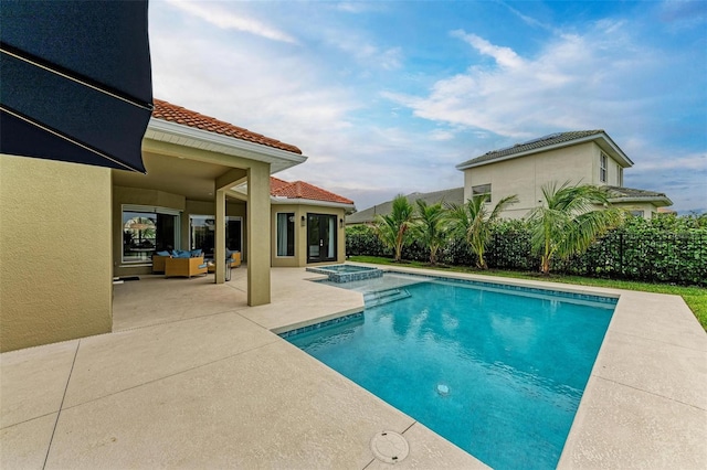 view of pool with a patio and an in ground hot tub