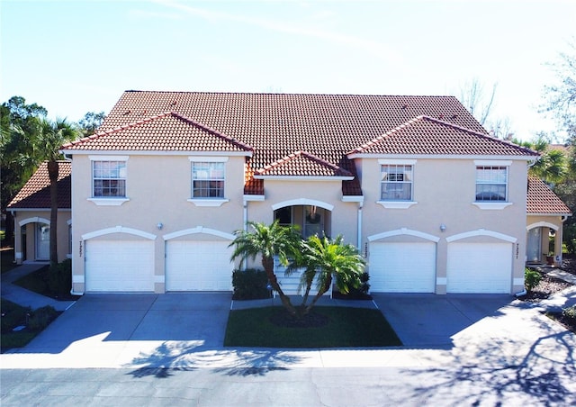 mediterranean / spanish-style home with a garage