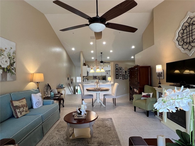 living room featuring ceiling fan, light tile patterned floors, and high vaulted ceiling