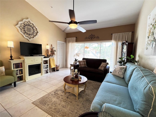 living room featuring tile patterned floors, ceiling fan, and vaulted ceiling