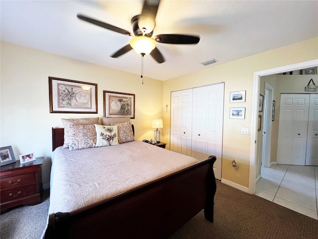 bedroom with ceiling fan, light tile patterned floors, and a closet