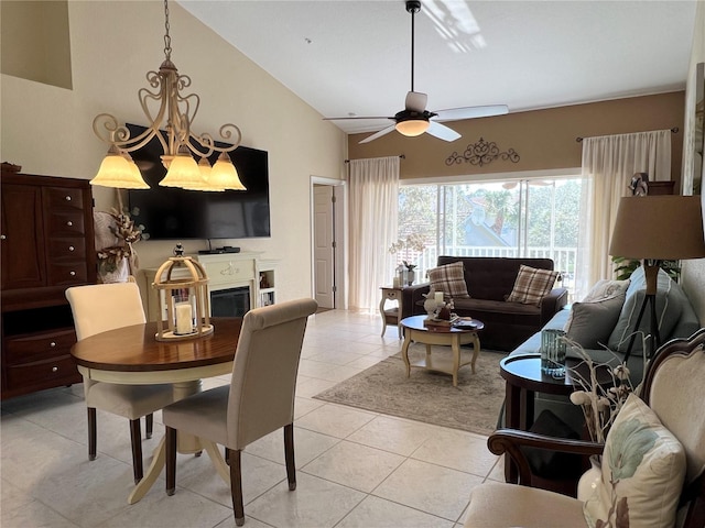 dining room featuring ceiling fan, light tile patterned flooring, and vaulted ceiling