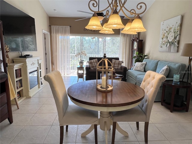 dining area featuring ceiling fan with notable chandelier and light tile patterned floors