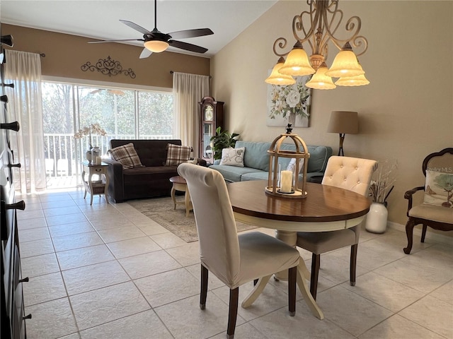 tiled dining space with ceiling fan with notable chandelier