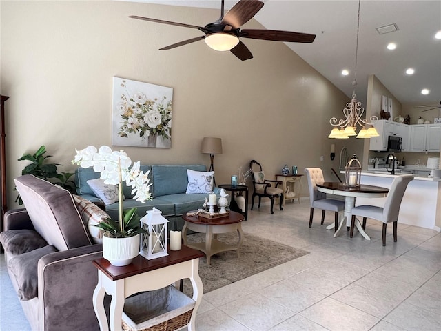 living room featuring ceiling fan, light tile patterned flooring, sink, and high vaulted ceiling