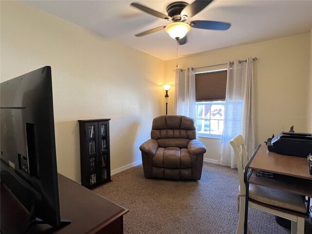 sitting room featuring carpet and ceiling fan