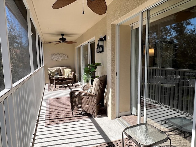 sunroom / solarium featuring ceiling fan