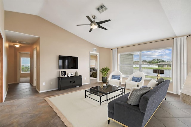 tiled living room with ceiling fan and lofted ceiling