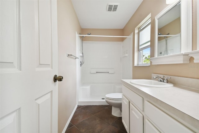 bathroom with toilet, vanity, tile patterned floors, and walk in shower