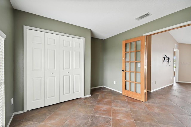 unfurnished bedroom featuring tile patterned floors and a closet