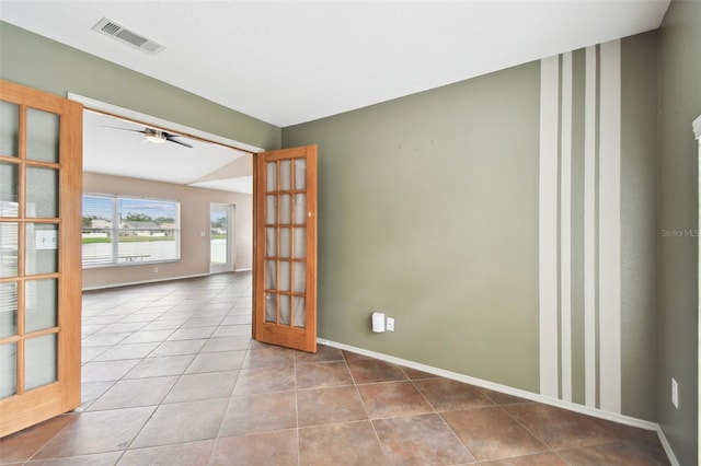 spare room featuring tile patterned flooring, french doors, and ceiling fan