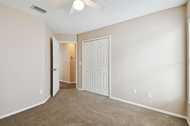 unfurnished bedroom featuring a closet, ceiling fan, and carpet flooring