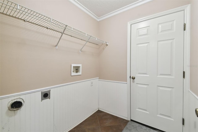 clothes washing area featuring hookup for an electric dryer, washer hookup, dark tile patterned flooring, crown molding, and a textured ceiling